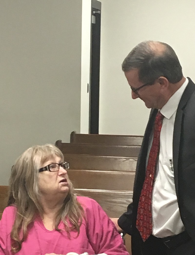 Virginia Hyatt, 69, speaks with a member of her defense team, Texarkana lawyer Bruce Condit, before a hearing Friday afternoon in a courtroom at the Miller County jail. Hyatt is appealing her 2016 capital murder conviction for the 2013 murder of Patti Wheelington in Texarkana, Ark. Friday's hearing was held to address issues with the trial's official record at the request of the Arkansas Supreme Court.