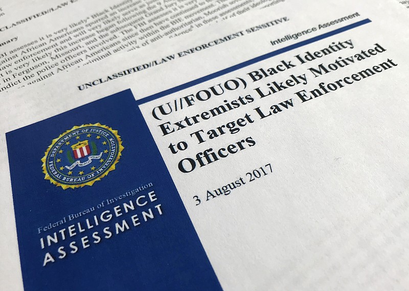 In this Nov. 17, 2017, photo, the cover page of a FBI report on the rise of black “extremists” is photographed in Washington. The report is stirring fears of a return to practices of the Civil Rights era, when the agency notoriously spied on activist groups without evidence they had broken any laws. Attorney General Jeff Sessions, a former Alabama senator whose career has been dogged by questions about race and his commitment to civil rights, did not ease lawmakers’ concerns when he was unable to answer questions about the report or its origins during a congressional hearing on Nov. 14. (AP Photo/Jon Elswick)