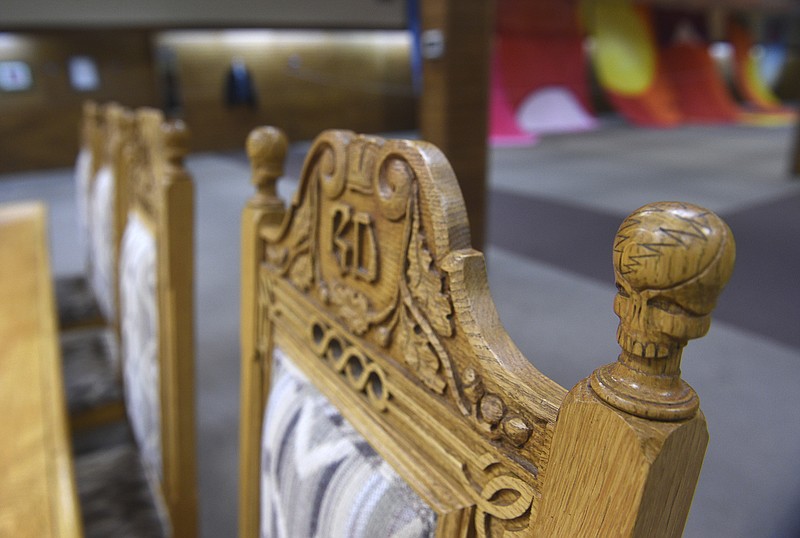 This Nov. 9, 2017, photo shows a replica of a conference table and chairs used by members of the Grateful Dead, along with a collection of Grateful Dead related memorabilia, at Stremmel Auctions in Reno, Nev. The widow of the Grateful Dead's longtime lawyer is auctioning off treasures from their long strange trip with the psychedelic rock-and-roll band.  Hal and Jesse Kant’s memorabilia collection includes signed artwork by the band’s late leader, Jerry Garcia, and backstage passes from concerts spanning 30 years.   (Jason Bean/The Reno Gazette-Journal via AP)