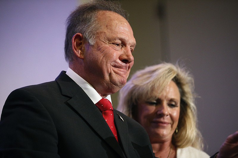 In this Nov. 16, 2017, photo, former Alabama Chief Justice and U.S. Senate candidate Roy Moore speaks at a news conference in Birmingham, Ala., with his wife Kayla Moore, right. A sex scandal has relegated Moore's hard-line positions on LGBT issues to the background in Alabama's turbulent Senate race even as religious activists blame the "LGBT mafia" and "homosexualist gay terrorism" for his precarious political plight. (AP Photo/Brynn Anderson)
