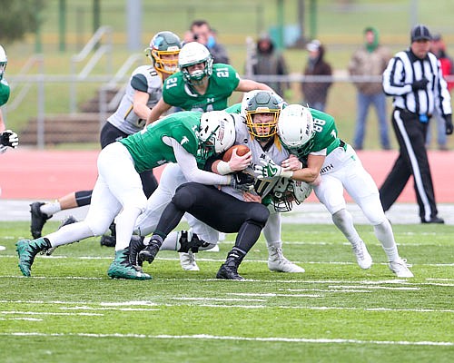 Blair Oaks teammates Jared Lootens (12) and Marcus Edler (88) s combine to tackle Maryville running back Jacob Reuter during Saturday afternoon's Class 3 semifinal game in Wardsville.
