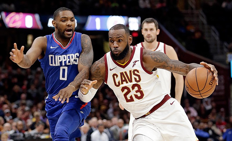Cleveland Cavaliers' LeBron James (23) drives past Los Angeles Clippers' Sindarius Thornwell (0) during the first half of an NBA basketball game, Friday, Nov. 17, 2017, in Cleveland. 