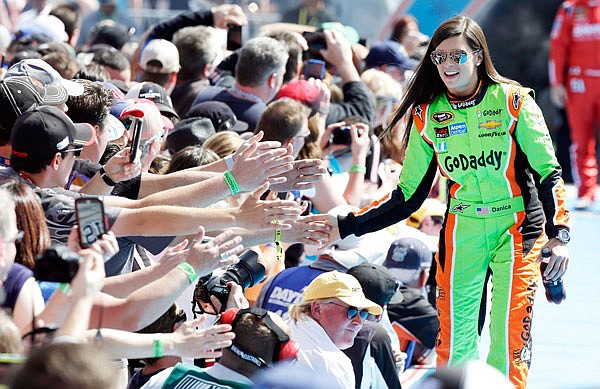 In this Feb. 22, 2015, file photo, driver Danica Patrick greets fans as she is introduced before the start of the Daytona 500 at Daytona International Speedway in Daytona Beach, Fla. Patrick announced plans Friday to run just two races in 2018, the Daytona 500 and the Indianapolis 500, and end her full-time driving career.