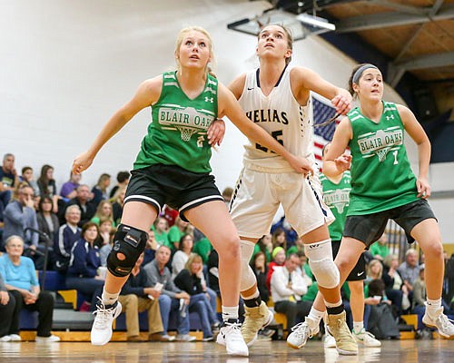 Macy Stockman (2) and Peyton Kusgen of Blair Oaks along with Ellie Rockers of Helias watch for the rebound on a free throw during Friday night's Jamboree at Helias.