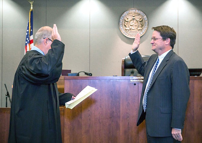 Retiring Judge Stanley Moore administers the oath of office to newly appointed 26th Circuit Court Judge Matthew Hamner.