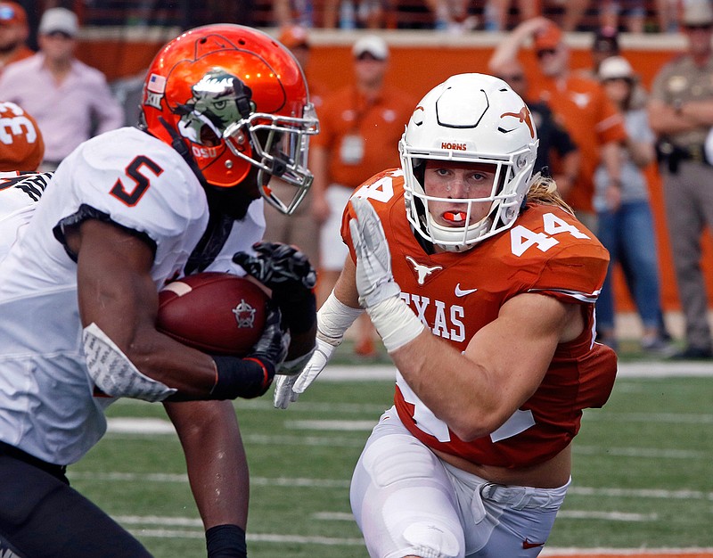  In this Oct. 21, 2017, file photo, Texas linebacker Breckyn Hager (44) pursues Oklahoma State running back Justice Hill (5) during the first half of an NCAA college football game in Austin, Texas. Texas plays at No. 24 West Virginia on Saturday. When asked about what makes playing at West Virginia a tough venue for opponents, Hager told reporters, "it's a bunch of hillbillies drinking moonshine." 