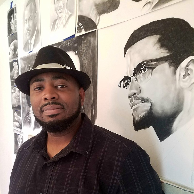 Cedric Watson poses in his music room at his Arkansas-side home on Tuesday. Several paintings and drawings, such as this depiction of Malcolm X, fill one wall in the room.