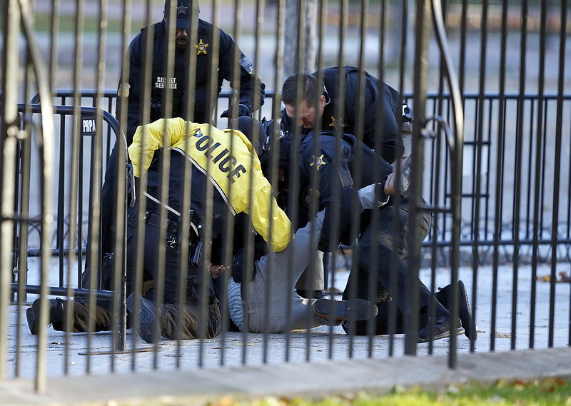 <p>AP</p><p>A man is subdued Sunday by officers of the Uniform Division of the U.S. Secret Service after he jumped the bike rack security barrier on the Pennsylvania Avenue side of the White House.</p>