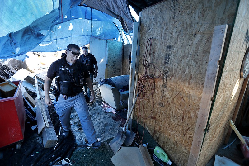 Officers from the Orange County Sheriff's Department and the Anaheim, Orange and Fountain Valley police departments have been clearing out homeless camps along the Santa Ana River trail. 