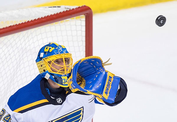 Blues goalie Jake Allen catches the puck during the third period of Saturday night's game against the Canucks in Vancouver, British Columbia.