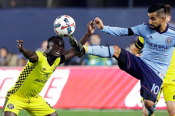 New York City FC's Maximiliano Moralez kicks the ball away from Mohammed Abu of the Columbus Crew during an MLS playoff match earlier this month in New York.