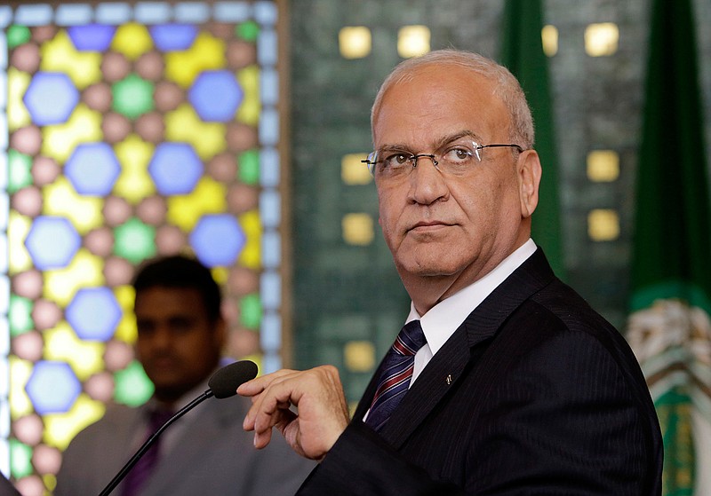 In this Aug. 11, 2014 file photo, Palestinian negotiator, Saeb Erekat, speaks during a news conference, following an emergency meeting at the Arab League headquarters in Cairo, Egypt.  The Palestinians threatened Saturday to suspend all communication with the Trump administration if it follows through with plans to shutter their diplomatic mission in Washington, dealing a potentially major blow to President Donald Trump's hopes of securing an elusive Mideast peace deal. Erekat said the U.S. decision would undermine the peace process, calling the move "very unfortunate and unacceptable."  