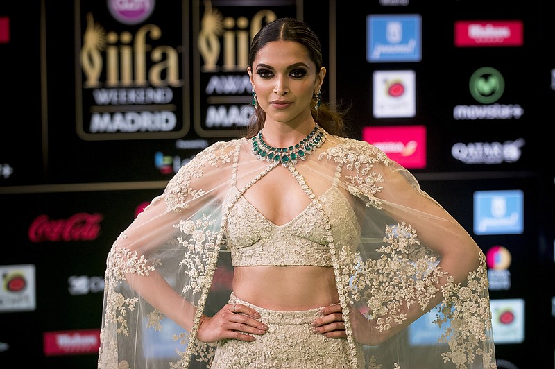 FILE - In this June 25, 2016 file photo, Bollywood actress Deepika Padukone poses for photographers at the International Indian Film Academy Rocks Green Carpet for the 17th Edition of IIFA Weekend & Awards in Madrid, Spain. A member of India's Hindu nationalist ruling party has offered a 100 million rupee ($1.5 million) reward to anyone who beheads the lead actress Padukone and  Sanjay Leela Bhansali, the director of the yet-to-be released Bollywood film "Padmavati" over its alleged handling of the relationship between a Hindu queen and a Muslim ruler.  The film's producers postponed the release of the film, which was set to be in theaters Dec. 1, 2017. (AP Photo/Samuel de Roman, File)
