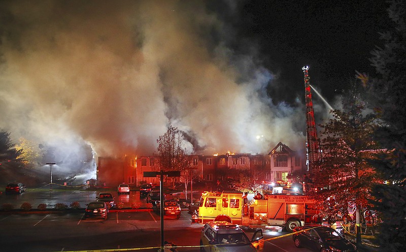 In this Thursday, Nov. 16, 2017 photo, fire fighters battle a blaze at the Barclay Friends Senior Living Community in West Chester, Pa. At least 20 people were injured in the massive fire at the senior living community about 35 miles west of Philadelphia.  (Steven M. Falk/The Philadelphia Inquirer via AP)