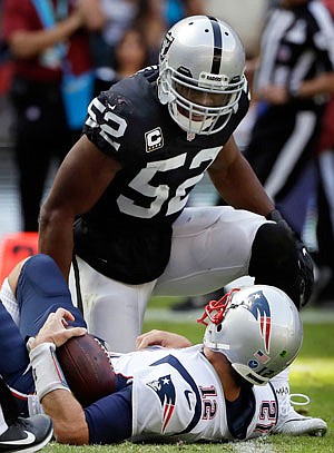 Patriots quarterback Tom Brady lies on the turf after he was sacked by Raiders defensive end Khalil Mack during Sunday's game in Mexico City.