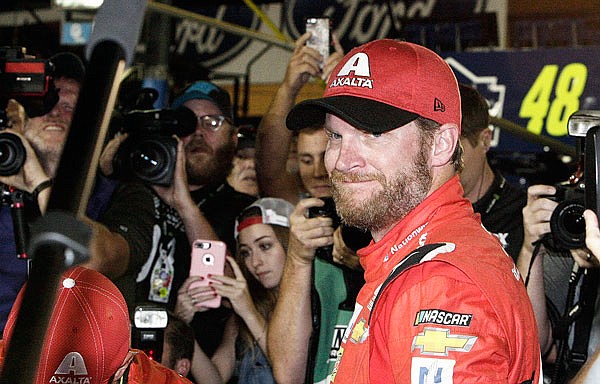 Dale Earnhardt Jr. is surrounded after getting out of his car Sunday at the end of the NASCAR Cup Series race at Homestead-Miami Speedway in Homestead, Fla.