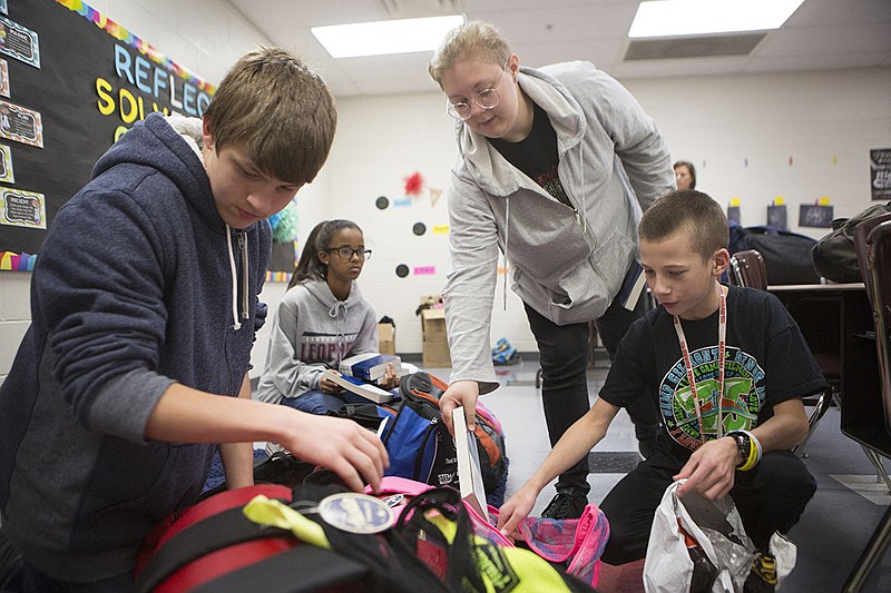 Gifted and talented students at Liberty-Eylau Middle School, above, stuff backpacks for the homeless as part of the Gifts from Grace project. Pictured from left are Daymon Finigan, Olivia Forte, Halley Tubb and Wade Bourne. 