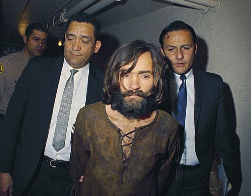  In this 1969 file photo, Charles Manson is escorted to his arraignment on conspiracy-murder charges in connection with the Sharon Tate murder case. Authorities say Manson, cult leader and mastermind behind 1969 deaths of actress Sharon Tate and several others, died Sunday. He was 83.