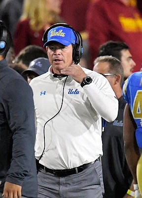 UCLA head coach Jim Mora walks the sideline during the second half of Saturday's game against Southern California in Los Angeles.