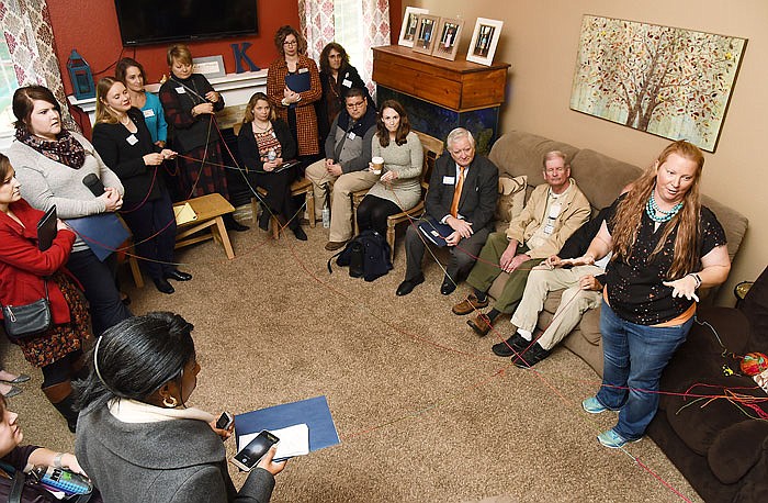 Erin Kremer,right, talks about being a foster care and adoptive mother to participants in this year's Central Missouri Foster Care and Adoption Association's bus tour. She used the yarn to talk about attachments, severed attachments and making new ones in foster care situations.