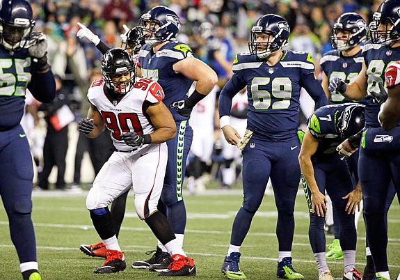Seahawks kicker Blair Walsh (far right) leans over with his hands on his knees as Derrick Shelby of the Falcons happily reacts to Walsh's missed field-goal attempt at the end of Monday night's game in Seattle.
