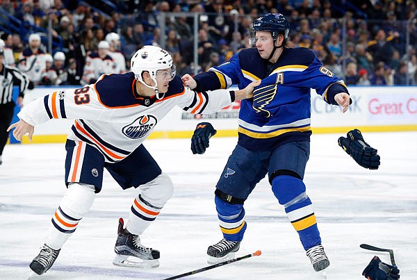 Vladimir Tarasenko of the Blues and Matt Benning of the Oilers drop the gloves and start to fight during Tuesday night's game in St. Louis.