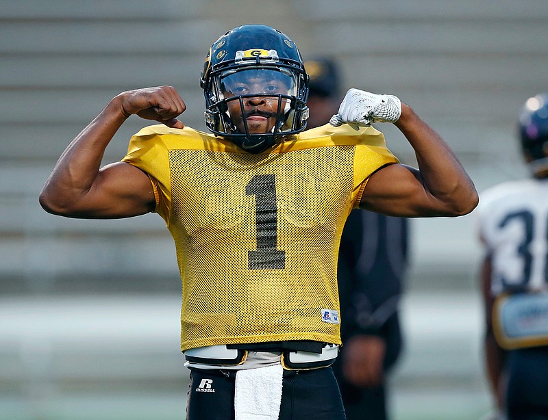 Grambling's senior quarterback Devante Kincade strikes a "muscleman" pose on the sidelines while waiting for his turn to run plays during practice, Thursday, Nov. 16, 2017, at Eddie G. Robinson Memorial Stadium in Grambling, La. Kincade, who played two seasons at Ole Miss, says playing football at a Historically Black College or University is an experience to savor. Playing at an HBCU is not just about entertaining halftime shows the schools are known for, it's about community.