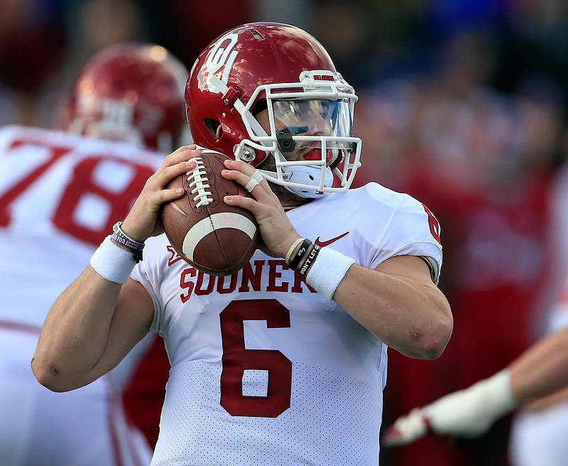 Oklahoma quarterback Baker Mayfield (6) looks for a receiver during the first half of an NCAA college football game against Kansas in Lawrence, Kan., Saturday, Nov. 18, 2017. 