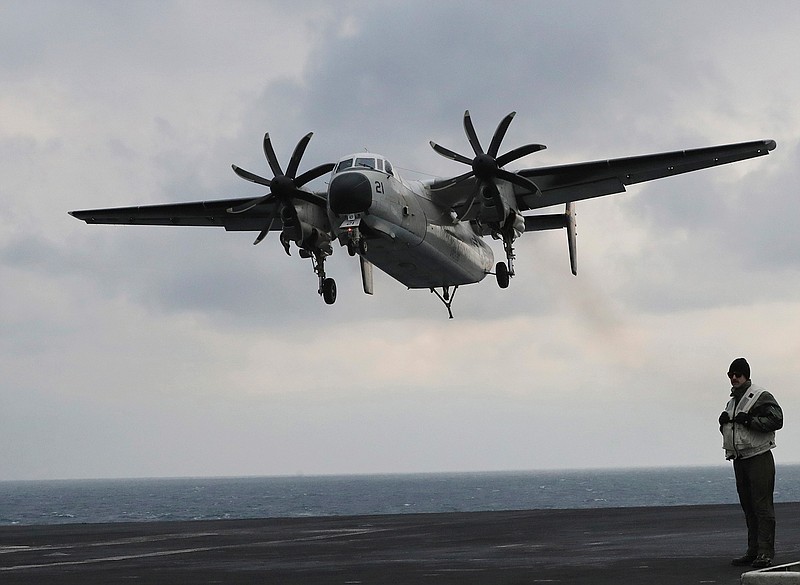 In this March 14, 2017, file photo, a U.S. Navy C-2 Greyhound approaches the deck of the Nimitz-class aircraft carrier USS Carl Vinson during the annual joint military exercise called Foal Eagle between South Korea and the United States at an unidentified location in the international waters, east of the Korean Peninsula. A similar type of the U.S. Navy plane carrying 11 crew and passengers crashed into the Pacific Ocean on Wednesday, Nov. 22, 2017, while on the way to the USS Ronald Reagan aircraft carrier, the Navy said. 