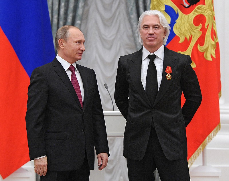 In this Dec. 10, 2015, file photo, Russian President Vladimir Putin, left, gives a state medal to world-renowned Russian baritone opera singer Dmitry Hvorostovsky during the award ceremony in the Kremlin in Moscow, Russia  Hvorostovsky died after a long battle with cancer. He was 55. Hvorostovsky's office said in a statement Wednesday, Nov. 22, 2017, that the acclaimed singer "died peacefully" earlier and was "surrounded by family" near his home in London.