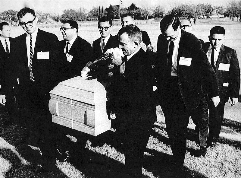 In this Nov. 25,1963, file photo, newsmen covering the funeral of accused presidential assassin Lee Harvey Oswald carry the casket to the grave site at Rose Hill Cemetery in Fort Worth, Texas, after pallbearers could not be found. President John F. Kennedy spent 12 hours in Fort Worth. It would be the last night of his life. But Oswald spent nine years in Benbrook and Fort Worth. He still lies here.