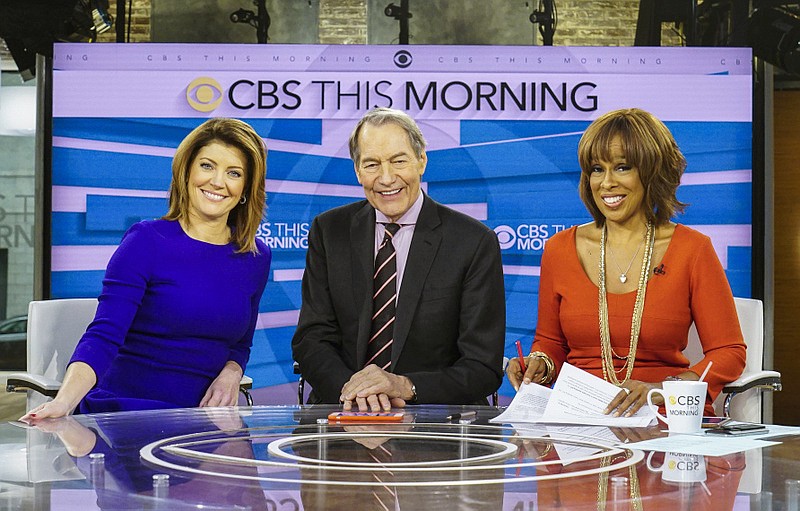 This image released by CBS shows, from left, Norah O'Donnell, Charlie Rose and Gayle King on the set of "CBS This Morning." Rose's co-hosts on "CBS This Morning" sharply condemned their suspended colleague Tuesday, Nov. 21, 2017, after the airing of sexual misconduct allegations that included groping female staffers and walking around naked in front of them, saying that it's a time of reckoning in society.