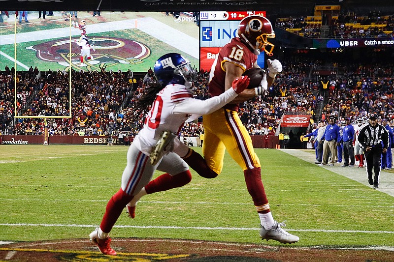 Washington Redskins wide receiver Josh Doctson (18) pulls in a touchdown pass under pressure from New York Giants cornerback Janoris Jenkins (20) during the second half of an NFL football game in Landover, Md., Thursday, Nov. 23, 2017.