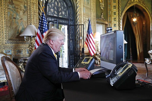 President Donald Trump speaks with members of the armed forces via video conference at his private club, Mar-a-Lago, on Thanksgiving, Thursday, Nov. 23, 2017, in Palm Beach, Fla.
