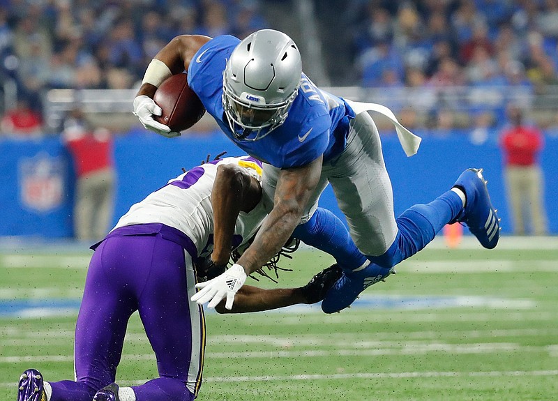 Minnesota Vikings cornerback Trae Waynes upends Detroit Lions running back Ameer Abdullah during the second half of an NFL football game, Thursday, Nov. 23, 2017, in Detroit.