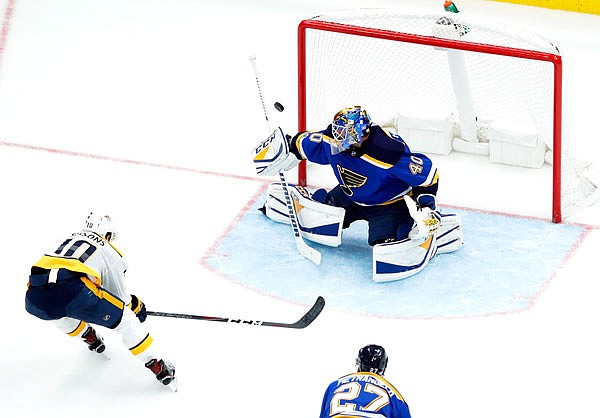Colton Sissons of the Predators (left) shoots wide of Blues goalie Carter Hutton during the second period of Friday's game in St. Louis.