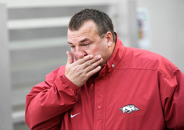 Arkansas coach Bret Bielema wipes away tears as the senior players are introduced before Friday's game against Missouri in Fayetteville, Ark. Bielema was fired following the team's 48-45 loss.