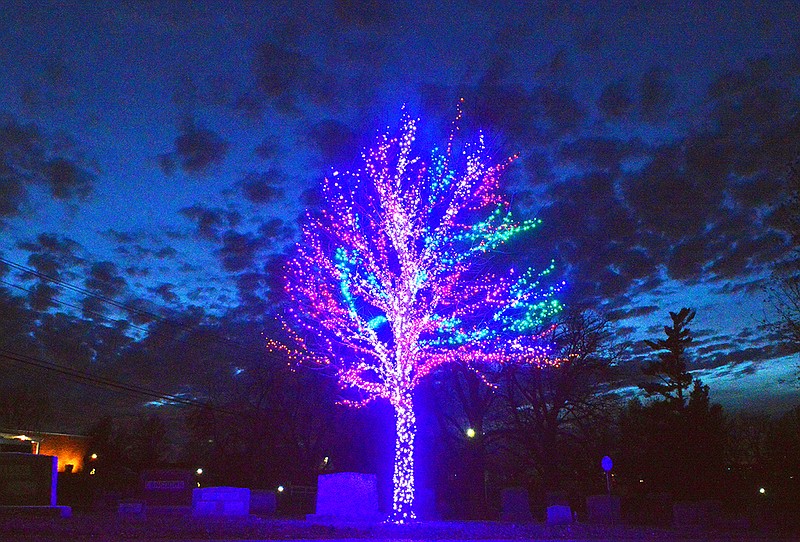 The Tree of Light comes to life Friday as the sun sets over Riverview Cemetery. 