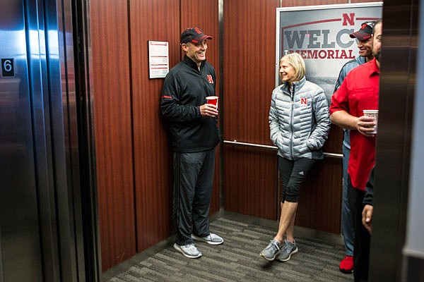 Mike Riley and his wife, Dee, stand in the elevator as they leave the press conference Saturday announcing his firing in Lincoln, Neb.