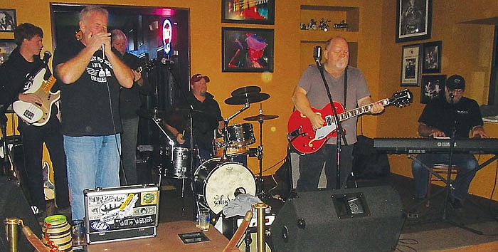 From left, Izzak Green on bass guitar and David Godsey on harmonica join usual blues players Robert Duckworth, Jake Hanselman, Kenny Hunt and Johnny D'Agostino at Sunday's blues jam at The Mission.