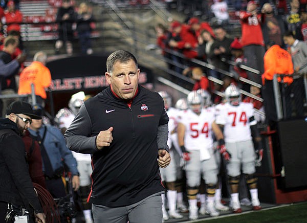 In this Sept. 30 file photo, Ohio State associate head coach Greg Schiano runs onto the field before a game against Rutgers in Piscataway, N.J.