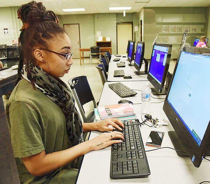 Solluna Collins looks up information on a a computer Monday at Missouri River Regional Library where she is a regular. MRRL is asking for donations on Giving Tuesday in hopes of reaching $10,000 in order to purchase Chrome Books, 3-D printers and install wireless printing capabilities. 