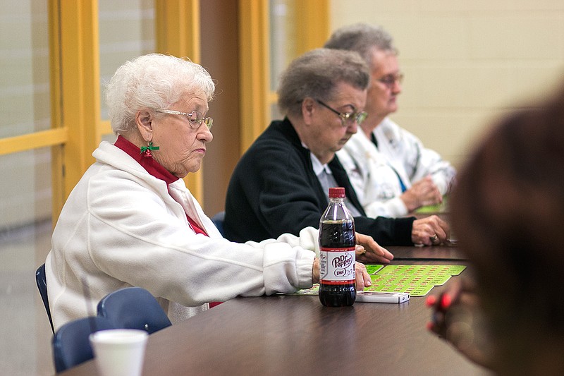 Helen Larsen looks at her cards after a number is called during Senior Bingo on Wednesday at the Southwest Center. Hospice of Texarkana comes to the center the last Wednesday of every month and gives seniors the opportunity to play a fun game of bingo. (Staff photo by Kayleigh Moreland)