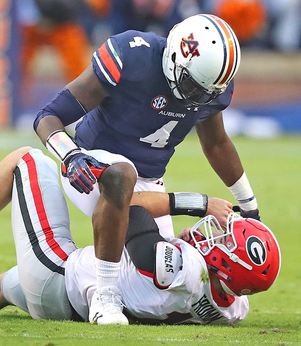 Auburn linebacker Jeff Holand tackles Georgia quarterback Jake Fromm during the first half of a Nov. 11 game in Auburn, Ala.