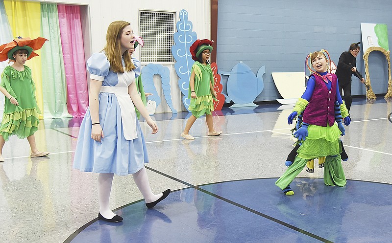 Students from Lighthouse Preparatory Academy prepare for this weekend's "Mad Hatter Tea Party" performances at the school and for Living Windows in downtown Jefferson City. Elena White, left as Alice, and Caitlyn Thompson, right as the butterfly, perform one of the show's musical numbers.