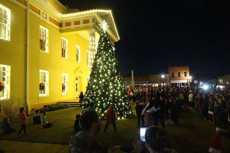 Linden, Texas, residents watch as their Christmas tree and courthouse light up Thursday. The tree is a first for the town, and the Cass County Commissioners Court sponsored the first major lighting of the courthouse. The event was celebrated with hot chocolate on the courthouse lawn. Approximately 5,000 lights were put on the courthouse.