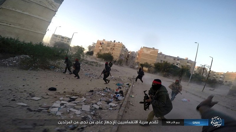 FILE - This photo posted on a file sharing website Wednesday, Jan. 11, 2017, by the Islamic State Group in Sinai, a militant organization, shows a deadly attack by militants on an Egyptian police checkpoint, in el-Arish, north Sinai, Egypt. The Egypt mosque massacre could point to the rise of an ultra-extremist faction that is so radical in its readiness to kill fellow Muslims that it has caused rifts within the Islamic State group _ already notorious for its atrocities.  (Islamic State Group in Sinai via AP, File )