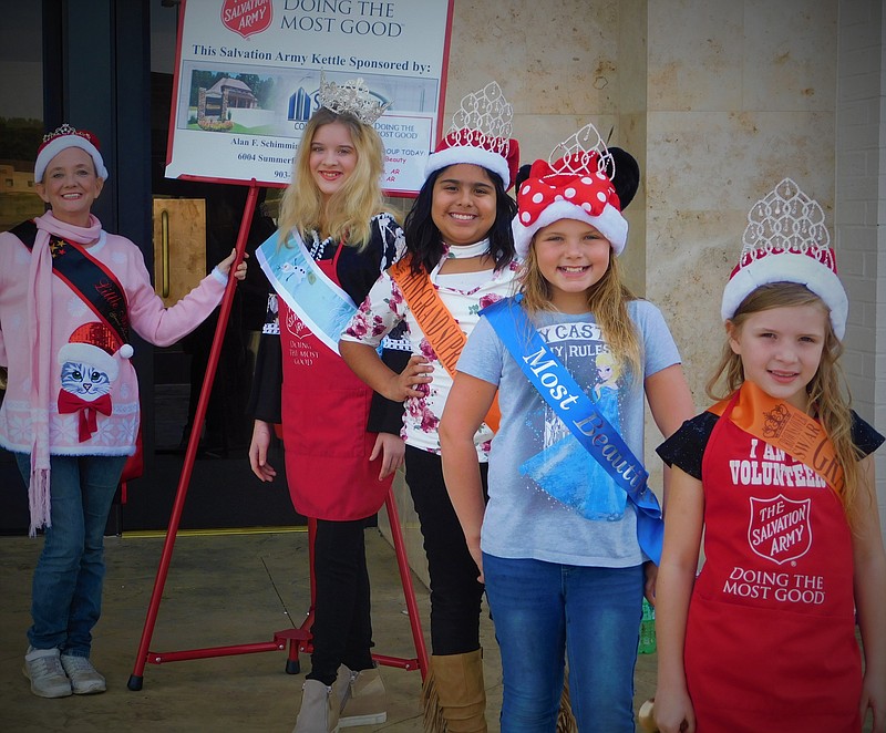 Circle of Beauty and Gingerbread Production for Arkansas Director Lisa Parker, left, of Camden, Ark., volunteers for the Salvation Army's Red Kettle campaign Saturday at Central Mall in Texarkana with pageant winners Shara Parker of Camden and Genesis Chavez, Isabella Martin and Heaven Martin of Hope, Ark. Shara founded Circle of Beauty to help pay pageant entry fees for children who can't and to get those children involved in community service. (Submitted photo)
