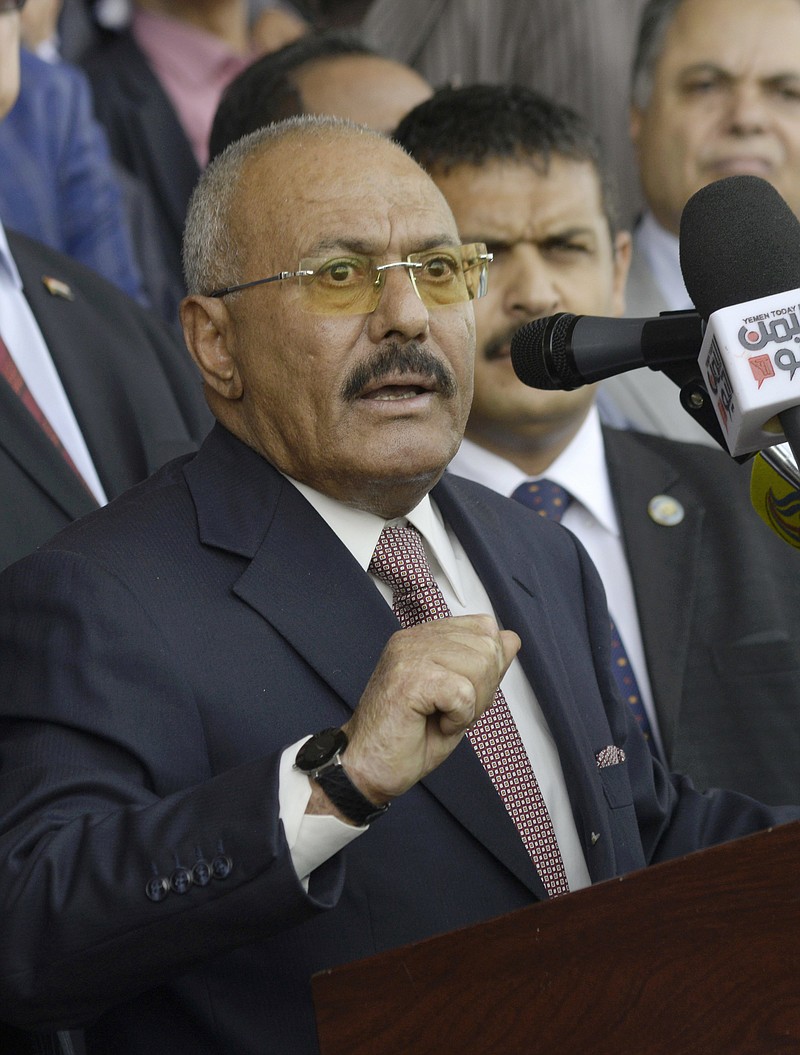 FILE - In this Aug. 24, 2017 file photo, former Yemeni President Ali Abdullah Saleh speaks during a ceremony to celebrate the 35th anniversary of the founding of the Popular Conference Party, in Sanaa, Yemen. Yemenis in the war-torn country's capital crowded into basements overnight, Monday Dec. 4, 2017, as Saudi-led fighter jets pounded the positions of Houthi rebels, who are now fighting forces loyal to Saleh for control of the city. A Sanaa-based protection and advocacy adviser for the Norwegian Refugee Council said Monday that the violence left aid workers trapped inside their homes and was "completely paralyzing humanitarian operations." (AP Photo/Hani Mohammed, File)