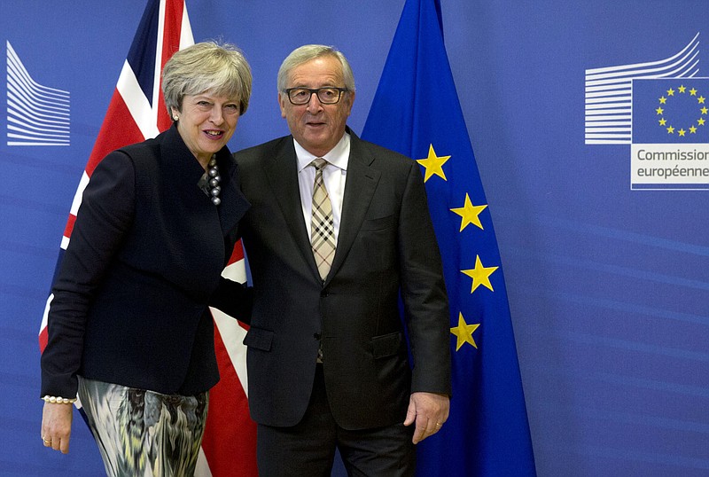 European Commission President Jean-Claude Juncker, right, greets British Prime Minister Theresa May prior to a meeting at EU headquarters in Brussels on Monday, Dec. 4, 2017. British Prime Minister Theresa May and EU Commission President Jean-Claude Juncker will hold a power lunch on Monday, seeking a breakthrough in the Brexit negotiations ahead of a key EU summit the week after. (AP Photo/Virginia Mayo)